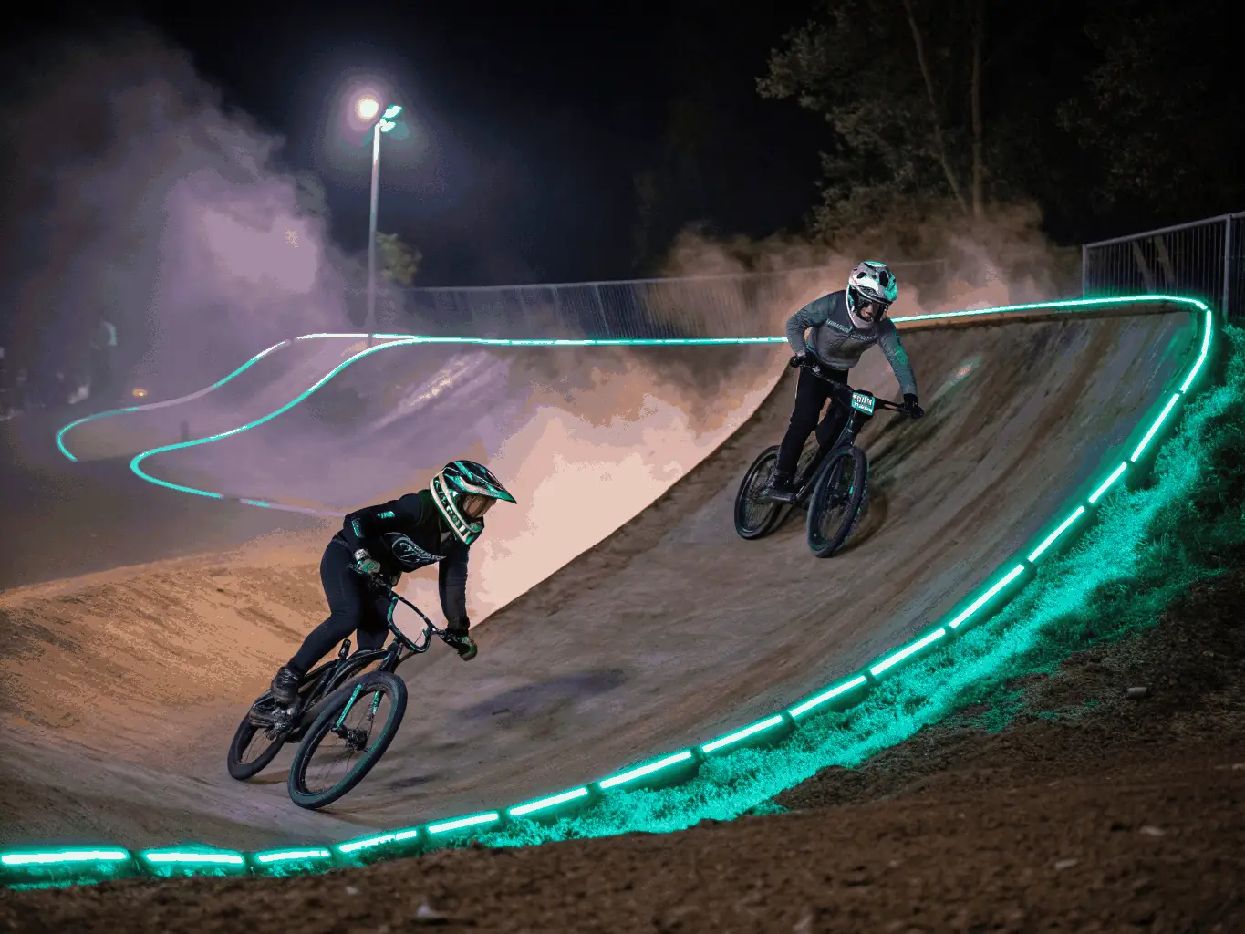 An action shot of participants engaging in a community BMX event organized by KTC, highlighting the excitement and camaraderie of the event.